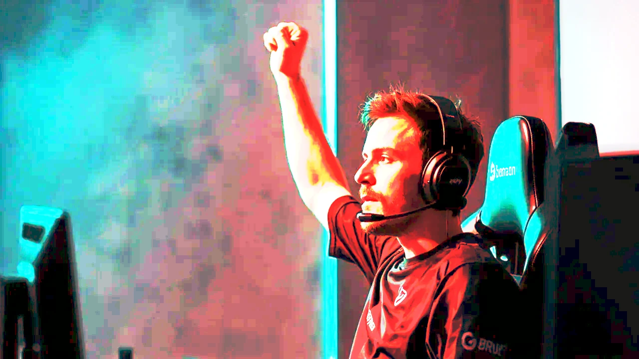 Player raising a fist in restrained celebration at the desk
